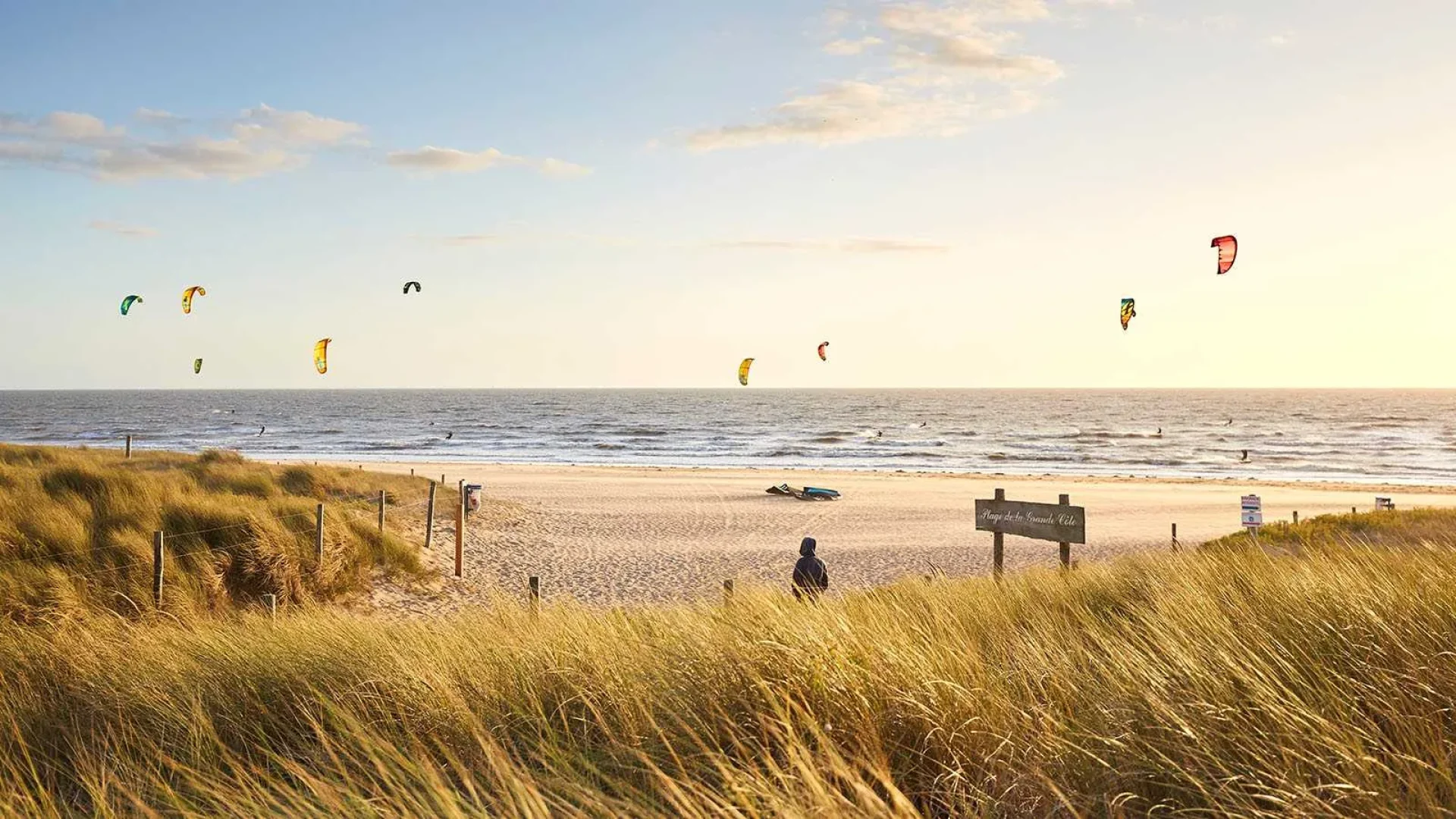 view of the dunes from people kite surfing on the grande côte beach at la barre de monts - fromentine